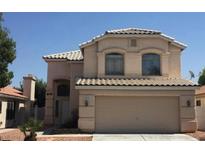 Two-story house exterior with a garage and landscaping at 9076 Quarrystone Way, Las Vegas, NV 89123
