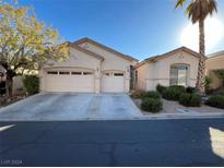 Three-car garage and desert landscaping at 10717 Refectory Ave, Las Vegas, NV 89135
