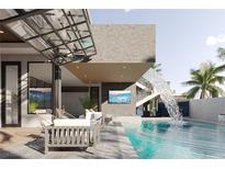 Relaxing patio with pool and waterfall, perfect for outdoor entertaining at 667 Scenic Rim Dr, Henderson, NV 89012