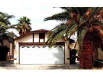 White garage door and palm trees in front of the house at 4224 Estaban Ct, Las Vegas, NV 89110