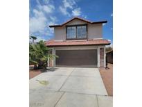 Two-story house with brown garage door and terracotta roof tiles at 6444 Deadwood Rd, Las Vegas, NV 89108