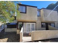 Tan colored two-story townhouse with double doors and small gated patio at 5049 Spencer St # D, Las Vegas, NV 89119