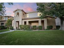 Two-story house with a manicured lawn, showcasing its architectural style and curb appeal at 11334 Colinward Ave, Las Vegas, NV 89135