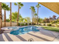 Relaxing kidney-shaped pool with a spa and lush landscaping at 1002 Prestige Meadows Pl, Henderson, NV 89052