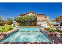 Luxury backyard oasis featuring a large pool, spa, and spacious patio area at 6391 Tempting Choice Ave, Las Vegas, NV 89131