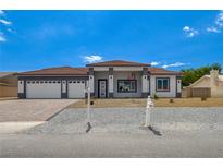 Single-story home with a two-car garage and a well-manicured front yard at 2150 S Manzanita Dr, Pahrump, NV 89048