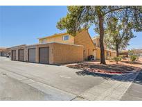 Exterior view of a townhome with attached garage at 5185 Gray Ln # J, Las Vegas, NV 89119