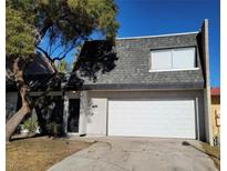 Two-story home with a gray roof and white garage door at 3364 Royce Ct, Las Vegas, NV 89121