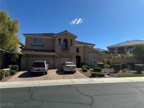 Two-story house with a three car garage and landscaped yard at 2742 Kingclaven Dr, Henderson, NV 89044