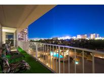 Evening balcony view overlooking a pool, city lights and golf course at 3111 Bel Air Dr # 8A, Las Vegas, NV 89109
