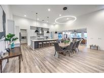 Open concept kitchen and dining area with modern lighting and stainless steel appliances at 3731 Caesars Cir, Las Vegas, NV 89120