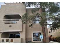 Two-story building exterior with balcony and parking at 1909 Villa Palms Ct # 109, Las Vegas, NV 89128