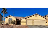Single-story house with two-car garage and desert landscaping at 6132 Peggotty Ave, Las Vegas, NV 89130