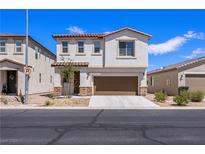 Two-story house with brown garage door and landscaping at 113 Parliament Cyn, Mesquite, NV 89027
