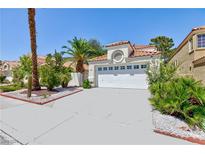 Single story home with a two car garage and desert landscaping at 1805 Derbyshire Dr, Las Vegas, NV 89117