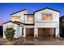 Two-story house with brown garage doors and Spanish-style architecture at 9009 Shifting Skye St, Las Vegas, NV 89166