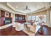 Spacious living room with hardwood floors, fireplace, and built-in shelving at 9205 Tesoras Dr # 401, Las Vegas, NV 89144