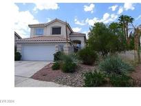 Two-story house with a red tile roof and landscaped front yard at 133 Tuxford Ct, Henderson, NV 89074