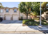 Two-story townhome with attached garage and well-manicured landscaping at 1607 Coal Valley Dr # 0, Henderson, NV 89014