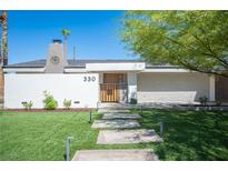 Modern single story home with landscaped lawn and walkway at 330 E Country Club Dr, Henderson, NV 89015