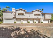 Three-unit building with attached garages and brick driveway at 109 Breezy Tree Ct # 202, Las Vegas, NV 89145