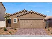 One-story house with two-car garage, landscaping, and brick driveway at 2764 Pavehawk Way, Las Vegas, NV 89156