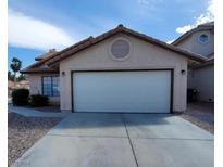 Single story home with attached garage and desert landscaping at 372 Rushing Creek Ct, Henderson, NV 89014