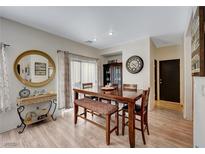 Charming dining room with hardwood floors and a wooden table at 1151 Maple Pines Ave, North Las Vegas, NV 89081