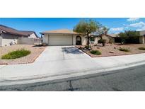 Single-story home with attached garage, desert landscaping, and paved driveway at 1009 Winwood St, Las Vegas, NV 89108