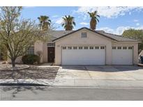 Single-story house with three-car garage and desert landscaping at 2257 Bridle Wreath Ln, Las Vegas, NV 89156