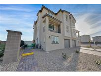 Modern three-story home with attached garage and walkway at 6952 Skyline Blue St, North Las Vegas, NV 89086