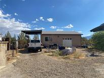 Single story home with carport and gravel driveway at 1081 W Wilson Rd, Pahrump, NV 89048