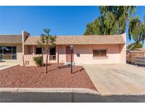 Single-story home with a light pink exterior and small front yard at 3711 Colonial Cir # 0, Las Vegas, NV 89121