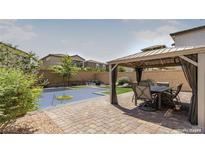 Backyard oasis with a pool, gazebo, and patio furniture at 10039 Silver Comet Ct, Las Vegas, NV 89178