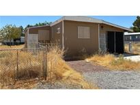 Brown mobile home with small yard at 291 Greenwater St, Pahrump, NV 89048