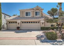 Two-story house with three car garage, mature landscaping, and a terracotta roof at 2112 Marble Gorge Dr, Las Vegas, NV 89117