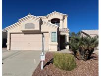 Two-story house with attached garage and desert landscaping at 8216 Carmen Blvd, Las Vegas, NV 89128