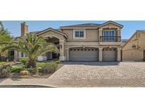 Two-story home with large driveway and palm trees at 4327 Melrose Abbey Pl, Las Vegas, NV 89141