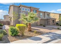 Two-story house with stone accents and palm tree at 6919 Denio Island St # 0, North Las Vegas, NV 89084