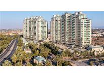 Luxury high-rise building with palm trees and gated entrance at 9101 Alta Dr # 16, Las Vegas, NV 89145