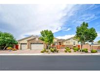 Single-story home with three-car garage and landscaped yard at 7290 Fresh Harvest Ave, Las Vegas, NV 89131