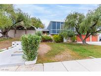 Mid-century modern home with mature trees and a large lawn at 2058 Ottawa Dr, Las Vegas, NV 89169