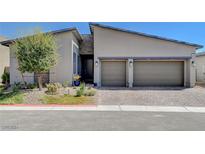 Modern two-car garage home with gray exterior and stone accents at 33 Reverie Heights Ave, Henderson, NV 89011