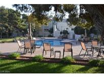 Community pool with surrounding patio furniture at 750 S Royal Crest Cir # 353, Las Vegas, NV 89169