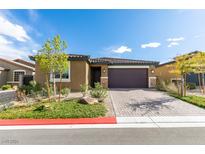 Single-story home with a two-car garage and landscaped yard at 4211 Callisto Ave, North Las Vegas, NV 89084