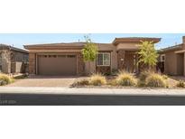 Modern home with a two-car garage and landscaped front yard at 91 Reflection Cove Dr, Henderson, NV 89011