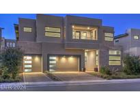 Modern two-story home with a two-car garage and landscaped yard at 10736 Patina Hills Ct, Las Vegas, NV 89135