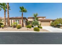 Single-story home with desert landscaping, two-car garage, and palm trees at 7316 Salvadora Pl, Las Vegas, NV 89113