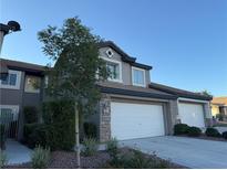 Two-story house with a three-car garage and stone accents at 10141 Velvet Dusk Ln # 0, Las Vegas, NV 89144