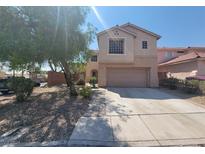 Two-story house with attached garage and landscaping at 1701 April Shower Pl, Las Vegas, NV 89144